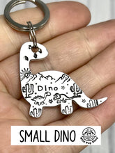 Load image into Gallery viewer, Dino Desert Scene • Personalised Name tag, ID Tag, Dog tag, Cat tag, Custom keyring, Silver Aluminium, Brass or Copper • Dinosaur, Mountain, Desert, Sun, Cactus, birds
